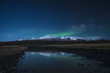 reflection-snow-covered-mountain-river-night.webp