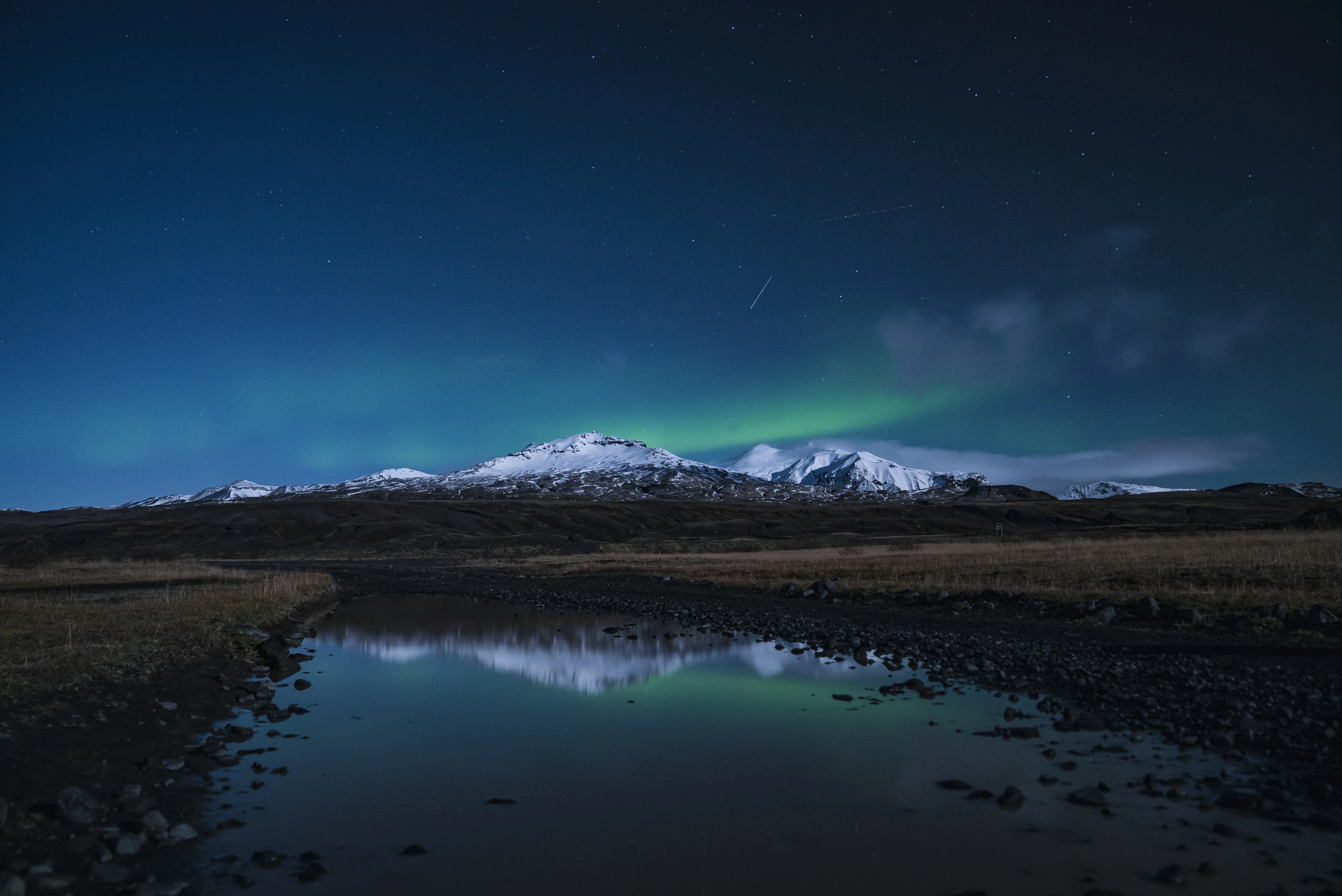 reflection-snow-covered-mountain-river-night.webp